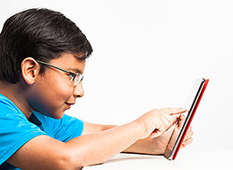 Photo of child playing on a tablet
